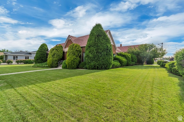 687 N Main St, Spanish Fork, UT 84660 - view of property exterior featuring a tile roof and a yard