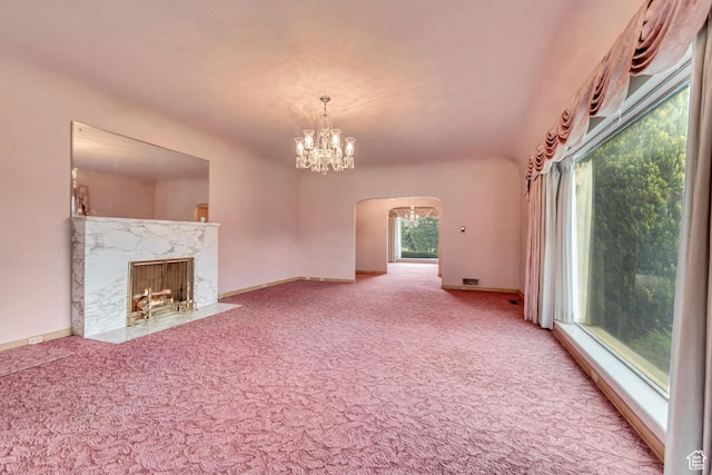 687 N Main St, Spanish Fork, UT 84660 - unfurnished living room featuring carpet, arched walkways, a chandelier, baseboards, and a premium fireplace