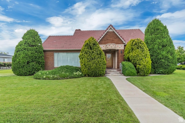 687 N Main St, Spanish Fork, UT 84660 - view of front of property featuring brick siding, a tile roof, and a front lawn