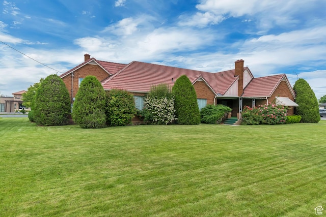 687 N Main St, Spanish Fork, UT 84660 - ranch-style house with a chimney, a tiled roof, and a front lawn
