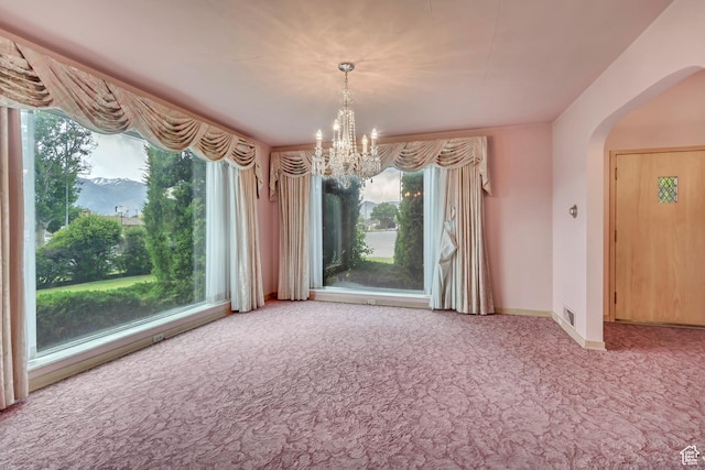 687 N Main St, Spanish Fork, UT 84660 - unfurnished dining area featuring carpet flooring, arched walkways, a chandelier, and plenty of natural light