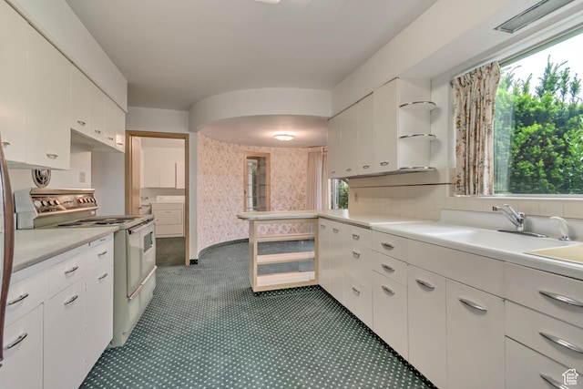 687 N Main St, Spanish Fork, UT 84660 - kitchen with electric range oven, light countertops, white cabinets, and a sink