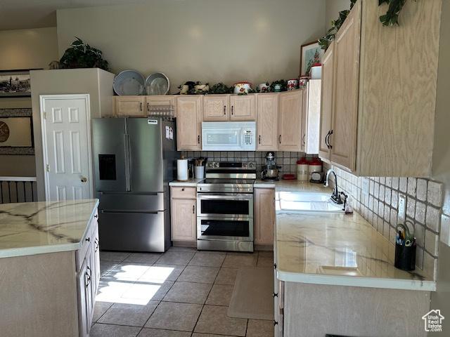 2025 E Skyline Dr, South Ogden, UT 84403 - kitchen featuring appliances with stainless steel finishes, a sink, tasteful backsplash, and light brown cabinets