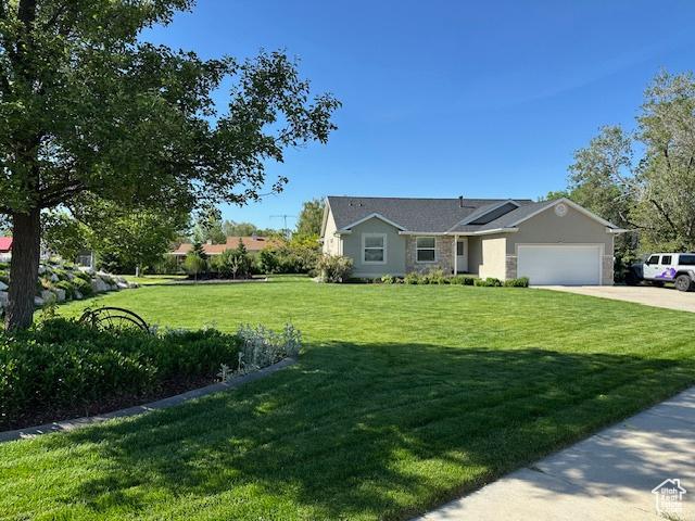 2025 E Skyline Dr, South Ogden, UT 84403 - ranch-style home with a garage, a front yard, and concrete driveway