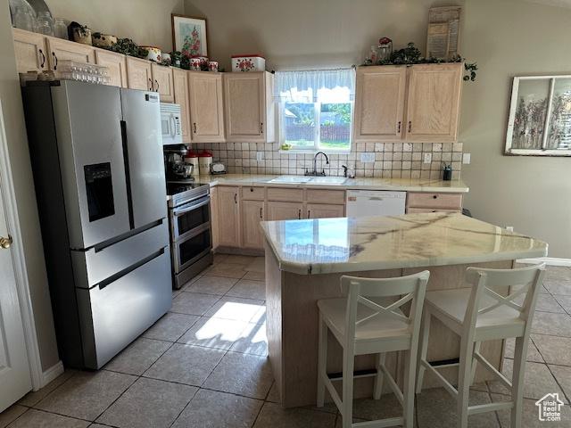 2025 E Skyline Dr, South Ogden, UT 84403 - kitchen featuring stainless steel appliances, a sink, tasteful backsplash, light tile patterned floors, and light brown cabinets