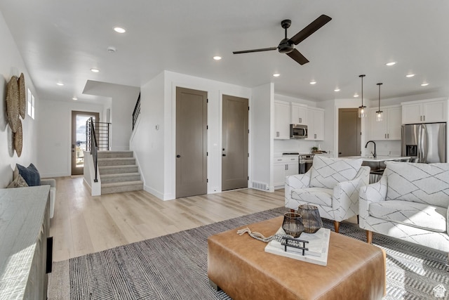 1471 E 1400 N Unit 55, Payson, UT 84651 - living area with a ceiling fan, light wood-style floors, baseboards, recessed lighting, and stairs