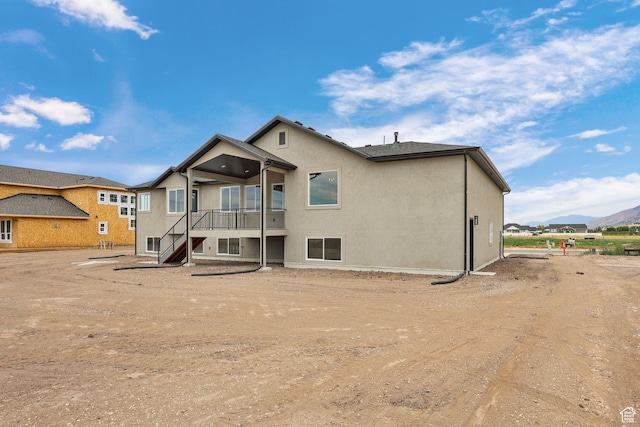 2409 W 3000 N, Farr West, UT 84404 - back of property featuring a mountain view, stucco siding, and stairway