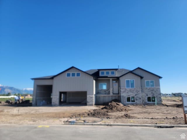 2409 W 3000 N, Farr West, UT 84404 - view of front of property featuring a garage, dirt driveway, and stone siding