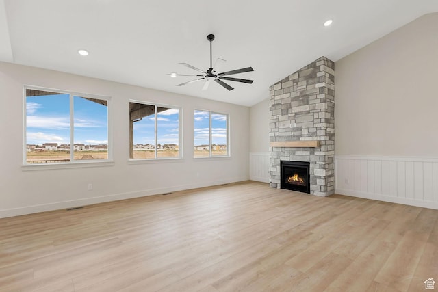 2409 W 3000 N, Farr West, UT 84404 - unfurnished living room featuring a ceiling fan, vaulted ceiling, light wood-style flooring, a stone fireplace, and recessed lighting