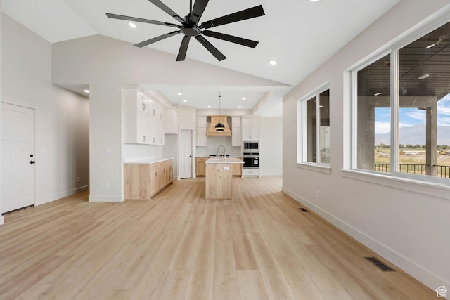 2409 W 3000 N, Farr West, UT 84404 - unfurnished living room featuring lofted ceiling, light wood-style floors, ceiling fan, and recessed lighting