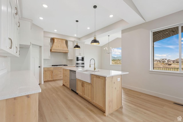 2409 W 3000 N, Farr West, UT 84404 - kitchen with custom range hood, light brown cabinetry, stainless steel appliances, light wood-style floors, and recessed lighting