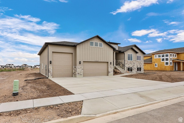 2409 W 3000 N, Farr West, UT 84404 - view of front of property with a garage, board and batten siding, driveway, and stone siding