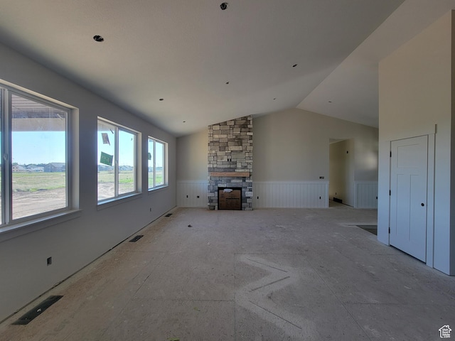 2409 W 3000 N, Farr West, UT 84404 - unfurnished living room featuring a wainscoted wall, a fireplace, and vaulted ceiling