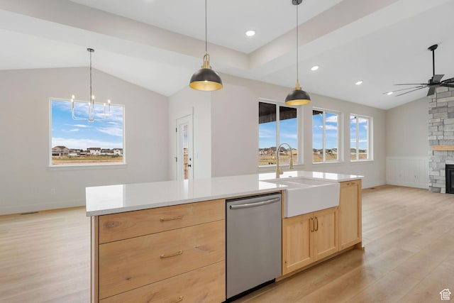 2409 W 3000 N, Farr West, UT 84404 - kitchen featuring stainless steel dishwasher, light brown cabinetry, vaulted ceiling, light wood-type flooring, and light countertops