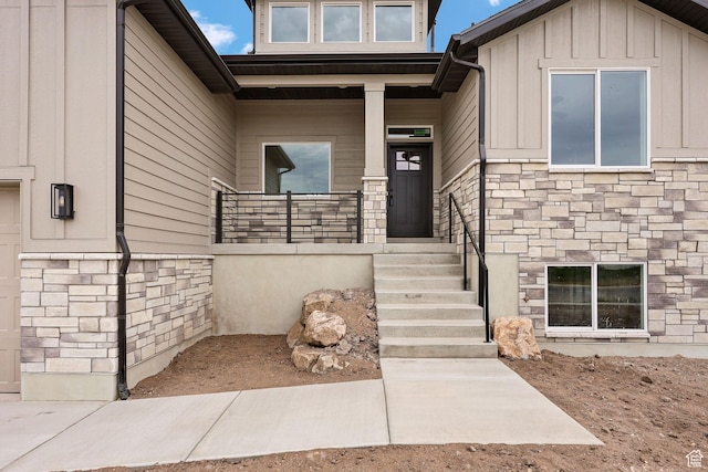 2409 W 3000 N, Farr West, UT 84404 - doorway to property featuring stone siding, board and batten siding, and covered porch