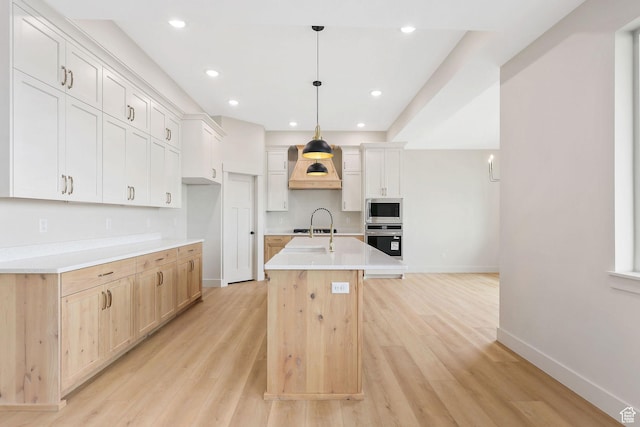 2409 W 3000 N, Farr West, UT 84404 - kitchen featuring appliances with stainless steel finishes, an island with sink, light countertops, light wood-type flooring, and recessed lighting