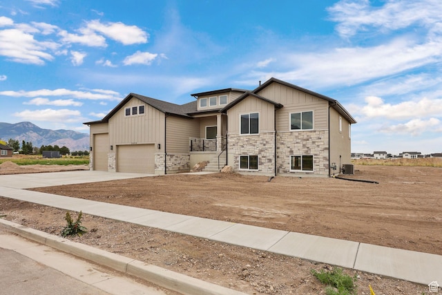 2409 W 3000 N, Farr West, UT 84404 - craftsman-style house featuring a mountain view, stone siding, driveway, and board and batten siding