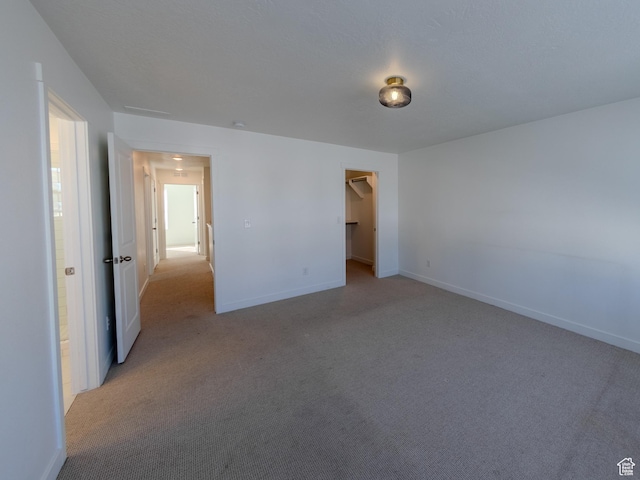 6654 W Skip Rock Rd S, South Jordan, UT 84009 - unfurnished bedroom with light carpet, baseboards, and a spacious closet
