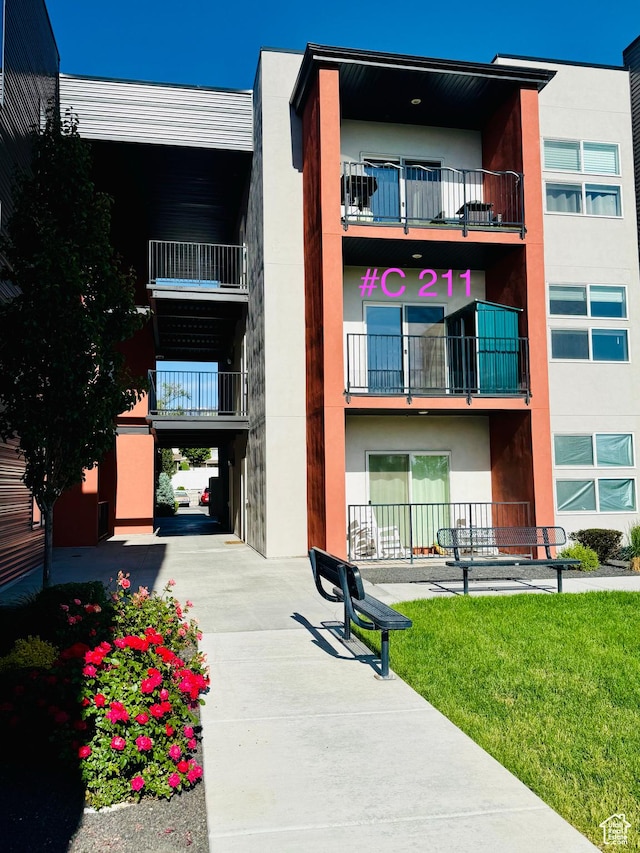 875 S Depot St Unit C211, Clearfield, UT 84015 - view of building exterior with a carport and driveway