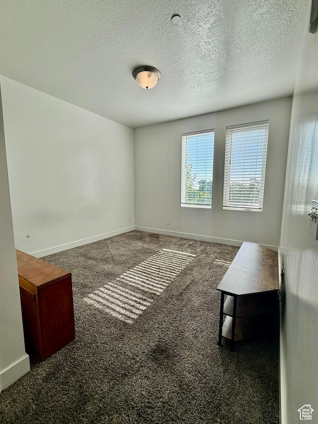 875 S Depot St Unit C211, Clearfield, UT 84015 - carpeted spare room featuring baseboards and a textured ceiling