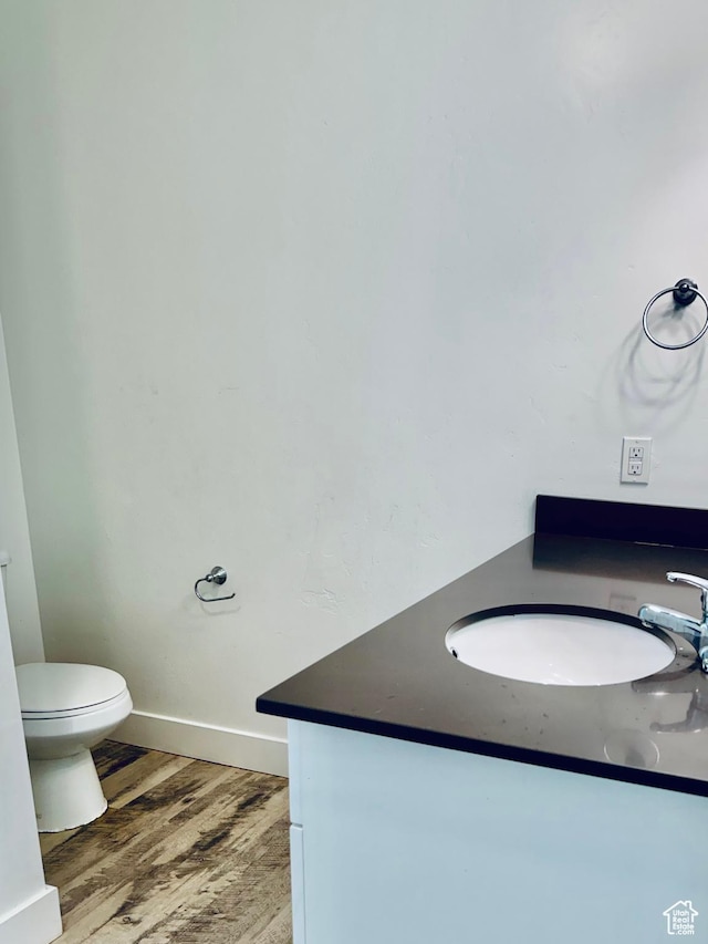 875 S Depot St Unit C211, Clearfield, UT 84015 - half bathroom featuring vanity, toilet, wood finished floors, and baseboards