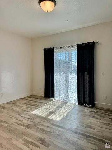 875 S Depot St Unit C211, Clearfield, UT 84015 - spare room featuring wood finished floors and baseboards