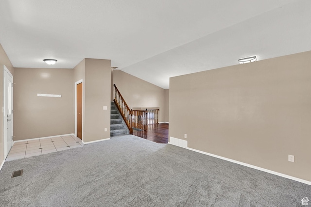 639 W 3750 S, Riverdale, UT 84405 - unfurnished living room with light colored carpet, baseboards, stairway, and lofted ceiling