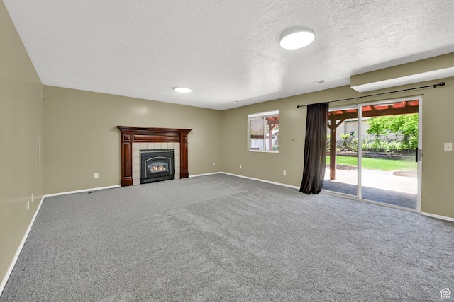 639 W 3750 S, Riverdale, UT 84405 - unfurnished living room featuring baseboards, carpet flooring, a fireplace, and a textured ceiling