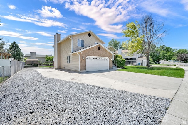 639 W 3750 S, Riverdale, UT 84405 - view of side of property with a chimney, driveway, brick siding, and a garage