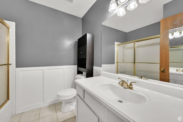 639 W 3750 S, Riverdale, UT 84405 - full bathroom with wainscoting, toilet, vanity, tile patterned floors, and a decorative wall
