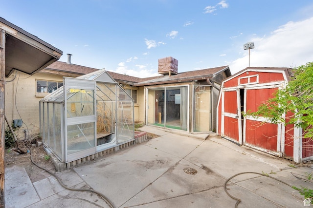 4655 W 4715 S, Salt Lake City, UT 84118 - rear view of house featuring an exterior structure, a patio area, and a chimney