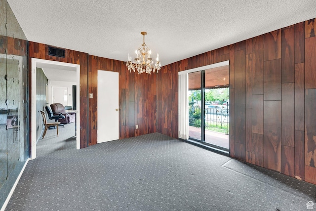 4655 W 4715 S, Salt Lake City, UT 84118 - empty room featuring carpet, wood walls, a chandelier, and a textured ceiling