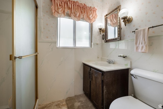 550 S 1500 W, Vernal, UT 84078 - bathroom featuring wallpapered walls, vanity, a wainscoted wall, toilet, and a shower with door