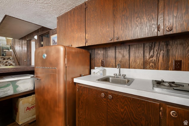 550 S 1500 W, Vernal, UT 84078 - kitchen featuring a sink, a textured ceiling, light countertops, freestanding refrigerator, and stainless steel gas cooktop