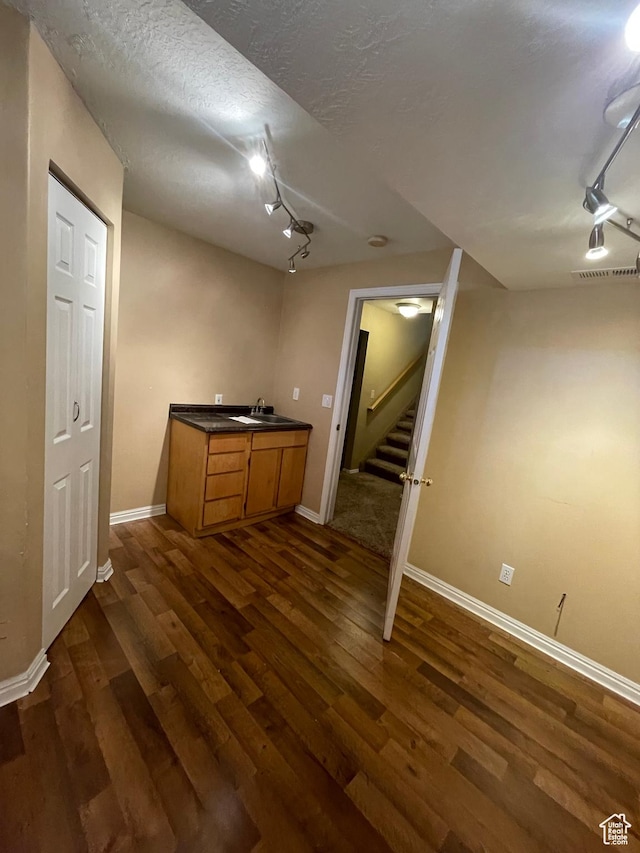 13778 S 2260 W, Riverton, UT 84065 - finished basement with rail lighting, a sink, dark wood-style flooring, and a textured ceiling
