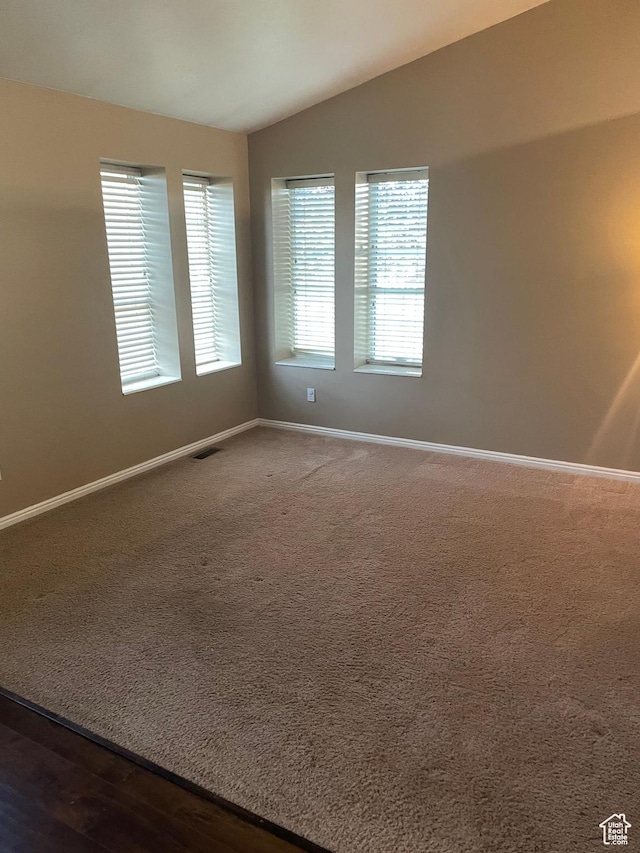 13778 S 2260 W, Riverton, UT 84065 - spare room featuring vaulted ceiling, baseboards, and dark colored carpet