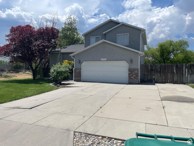 13778 S 2260 W, Riverton, UT 84065 - traditional-style home featuring driveway, an attached garage, stucco siding, and brick siding
