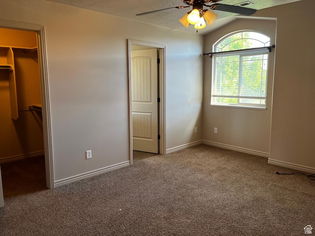 1126 W Lancelot Ln, West Haven, UT 84401 - unfurnished bedroom featuring carpet flooring, baseboards, a walk in closet, and ceiling fan