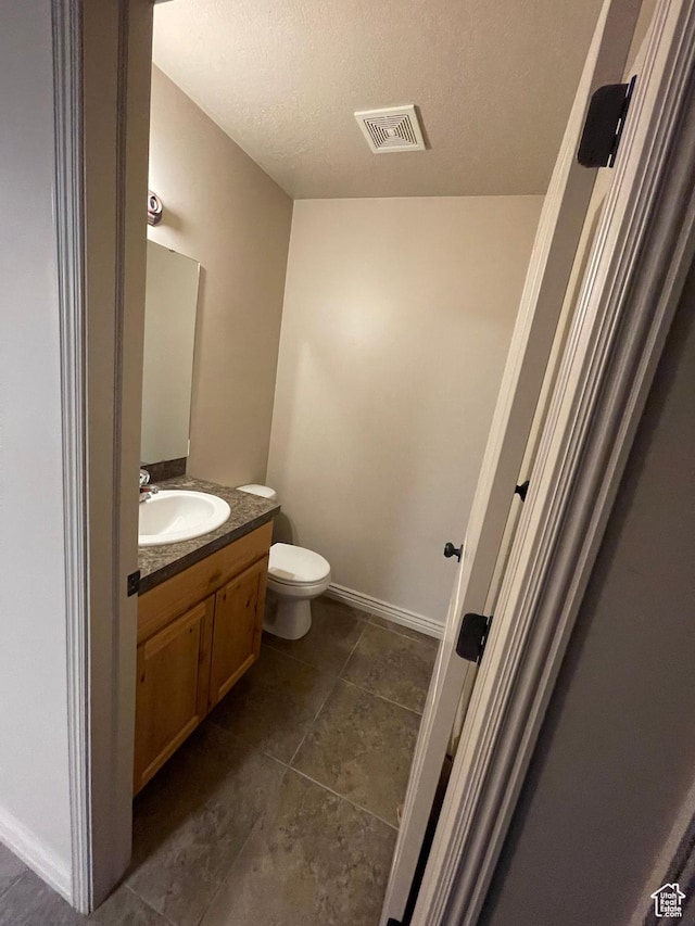 1126 W Lancelot Ln, West Haven, UT 84401 - half bath featuring vanity, toilet, tile patterned flooring, and a textured ceiling