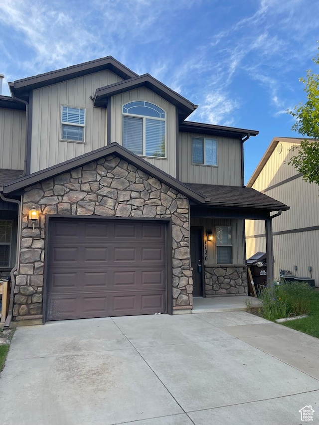 1126 W Lancelot Ln, West Haven, UT 84401 - view of front facade with stone siding, driveway, board and batten siding, and a garage