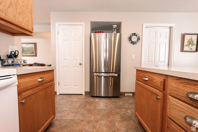 1969 N 275 W, Harrisville, UT 84414 - kitchen featuring freestanding refrigerator, light countertops, and brown cabinetry