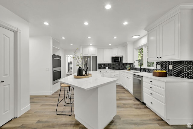 4781 Canterbury Rd, South Ogden, UT 84403 - kitchen with stainless steel appliances, a sink, white cabinetry, and recessed lighting