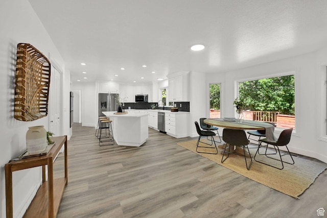 4781 Canterbury Rd, South Ogden, UT 84403 - dining room featuring healthy amount of natural light, light wood-style floors, recessed lighting, and baseboards