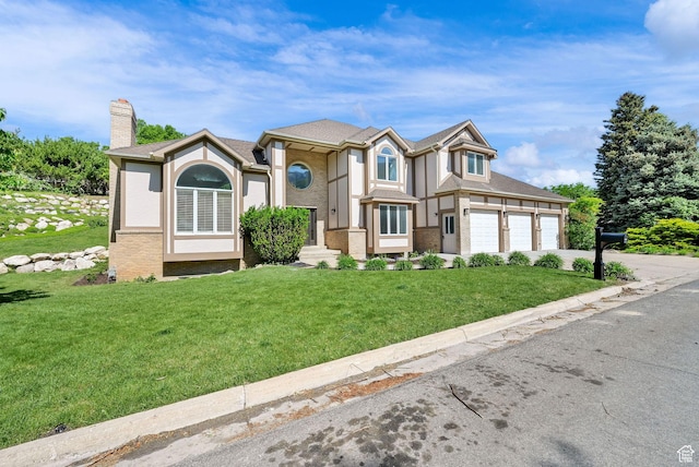 4781 Canterbury Rd, South Ogden, UT 84403 - view of front facade with driveway, a chimney, a front yard, an attached garage, and brick siding