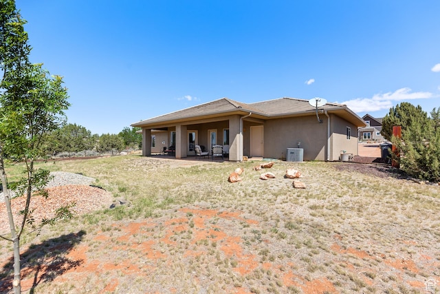 1374 E Big Pinion Ln, Apple Valley, UT 84737 - rear view of house with stucco siding, a patio area, and central air condition unit