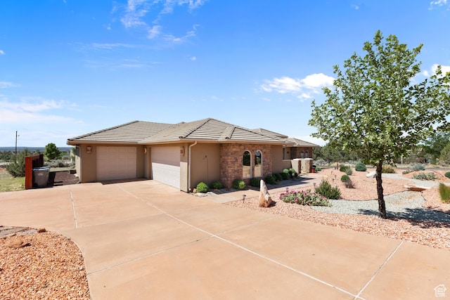 1374 E Big Pinion Ln, Apple Valley, UT 84737 - ranch-style home featuring a tiled roof, an attached garage, stucco siding, driveway, and stone siding