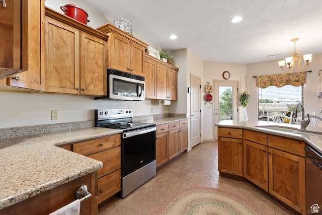 1374 E Big Pinion Ln, Apple Valley, UT 84737 - kitchen with appliances with stainless steel finishes, a sink, a chandelier, brown cabinets, and light stone counters