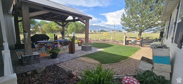 6897 S 4000 W, Benjamin, UT 84660 - view of green lawn with a gazebo, a mountain view, and a patio