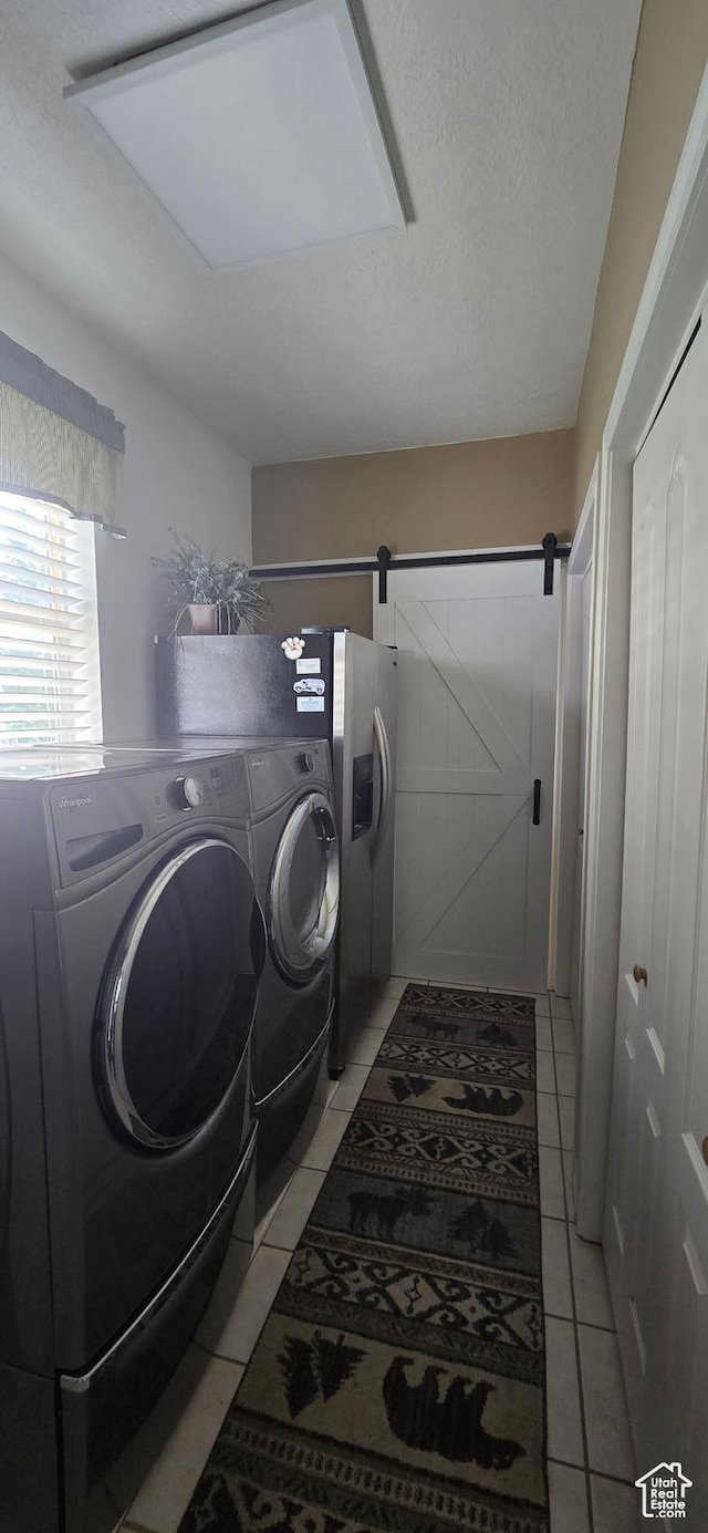 6897 S 4000 W, Benjamin, UT 84660 - laundry room with light tile patterned floors and separate washer and dryer