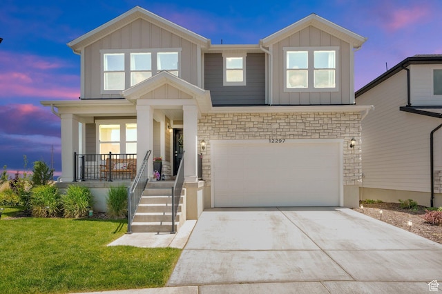 12297 S Boggs Way, Herriman, UT 84096 - view of front facade with board and batten siding, a porch, concrete driveway, and a garage